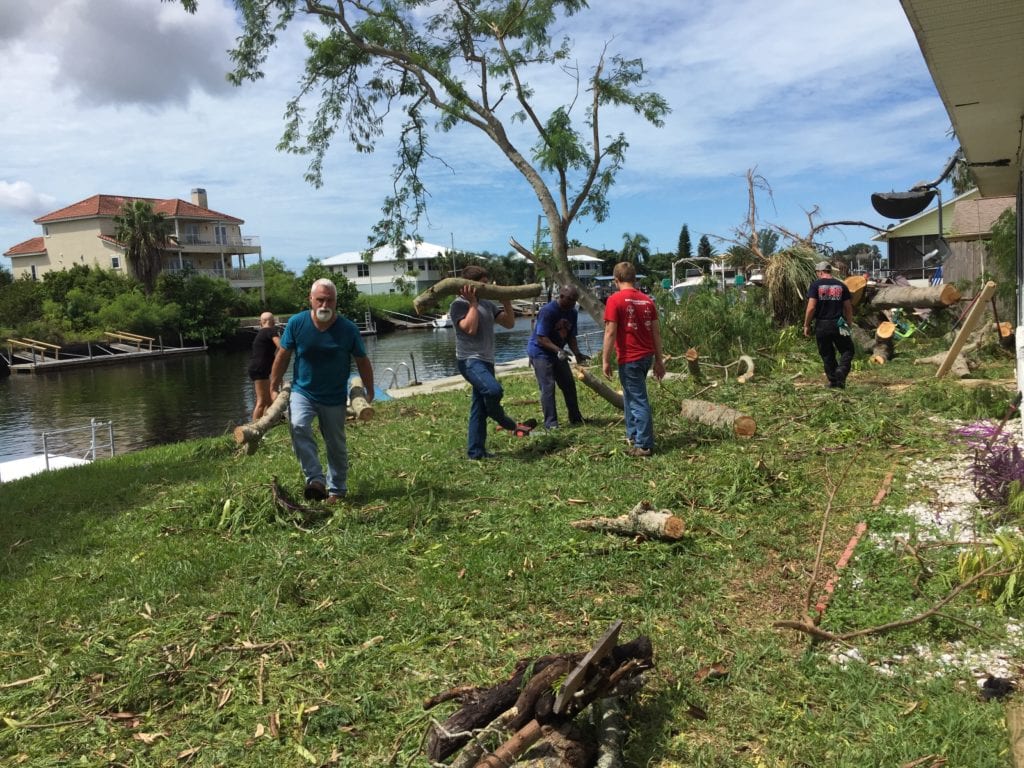 Hernando Beach residents and local volunteers work together to clean up residential debris.