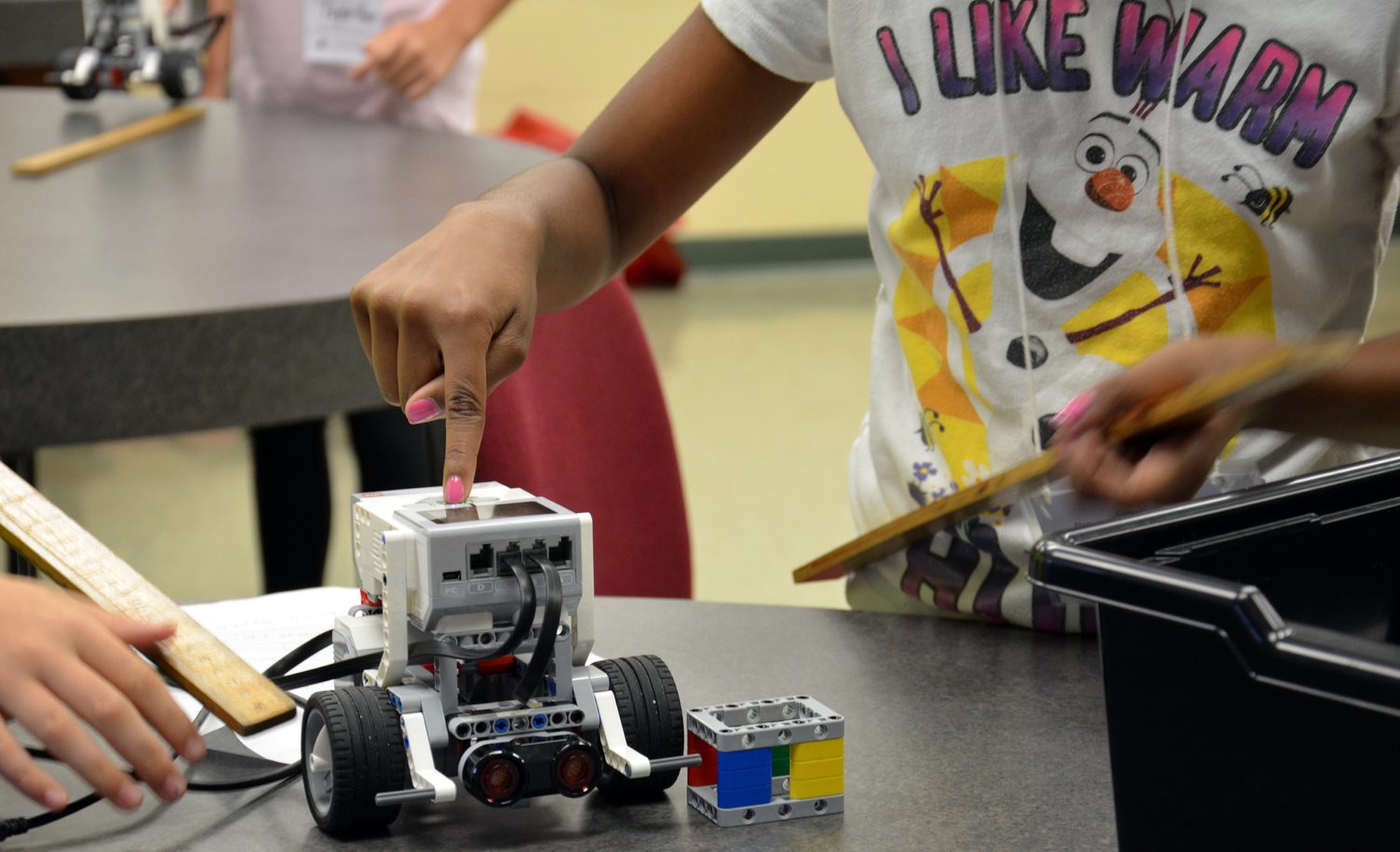 Students work on a robot during a previous robotics summer camp at Saint Leo University.