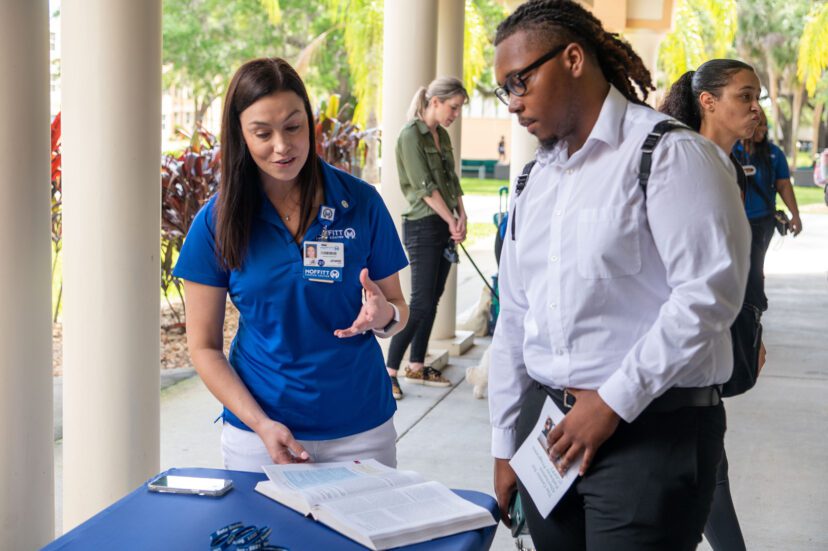 Saint Leo University senior Maurice Ferguson, who is majoring in computer science, talks with Jennie Jones, director, cancer registry/surveillance informatics at Moffitt about the cancer registry profession and the Certified Tumor Registrar® exam.